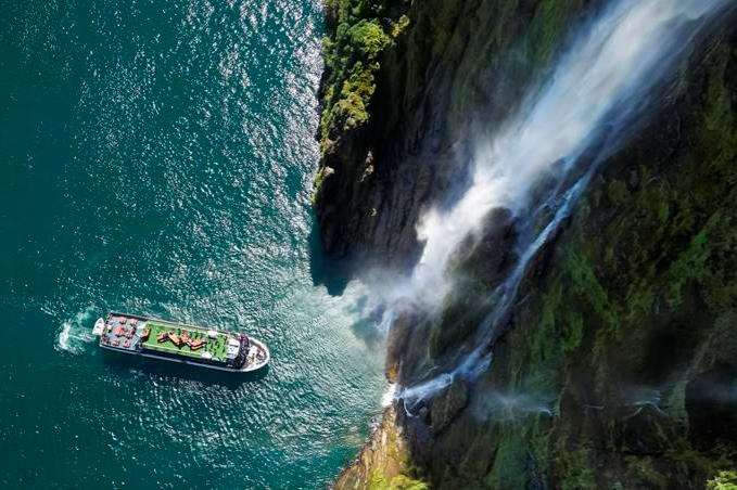New Zealand South Island Milford Sound waterfall and cruise boat